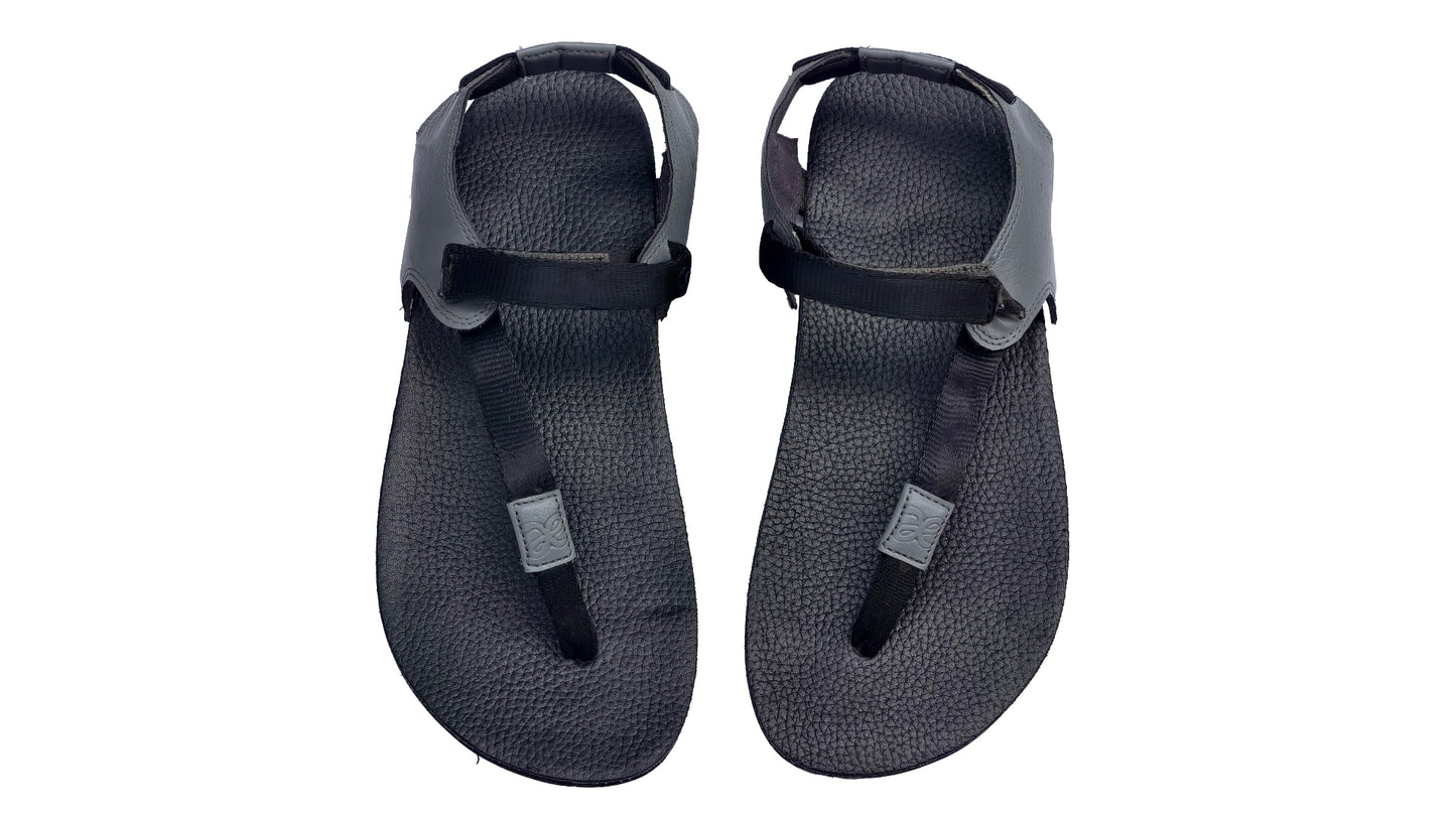 Pair of black sandals with straps on a white background
