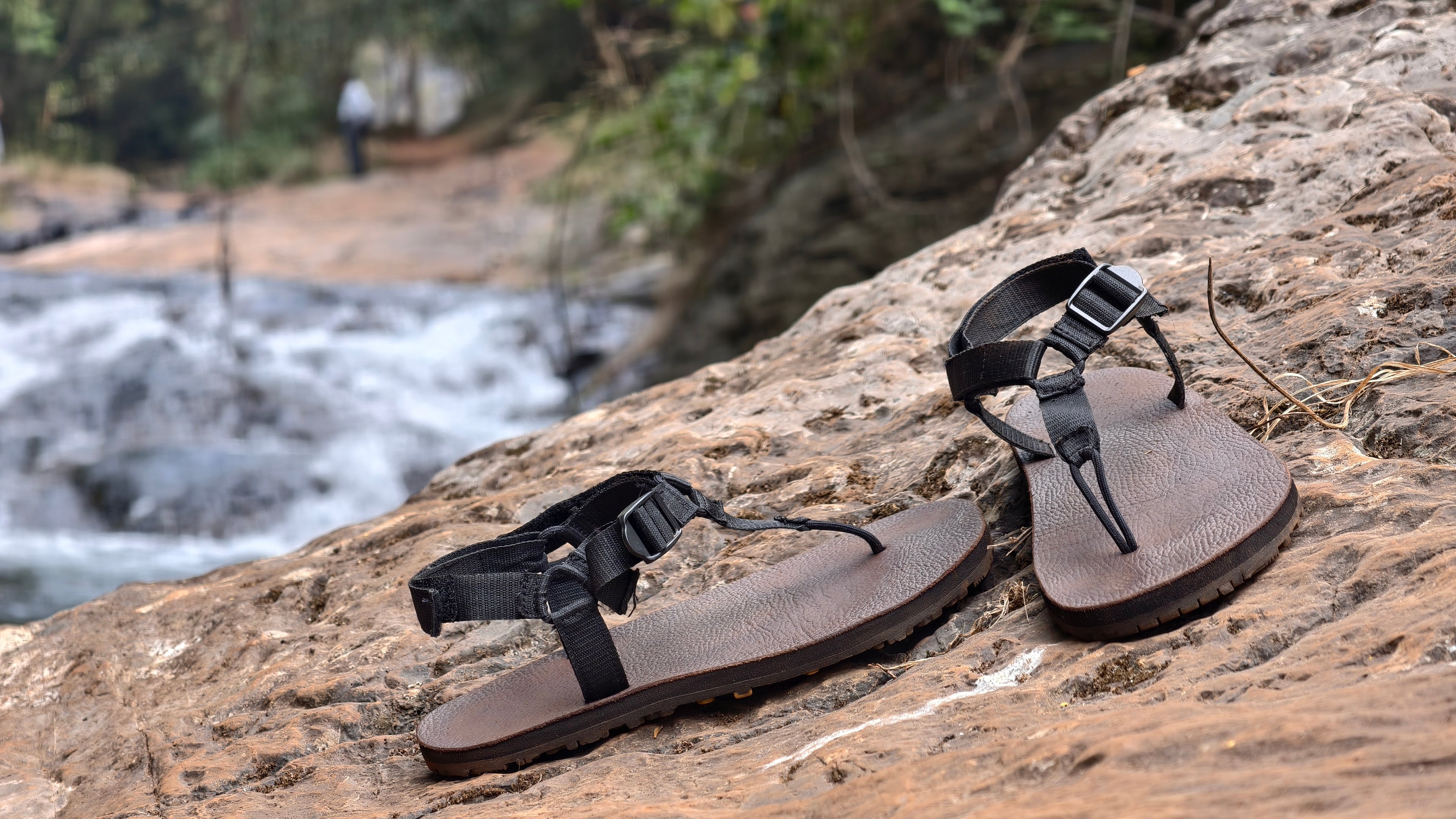 Pair of sandals on a rock with a natural background