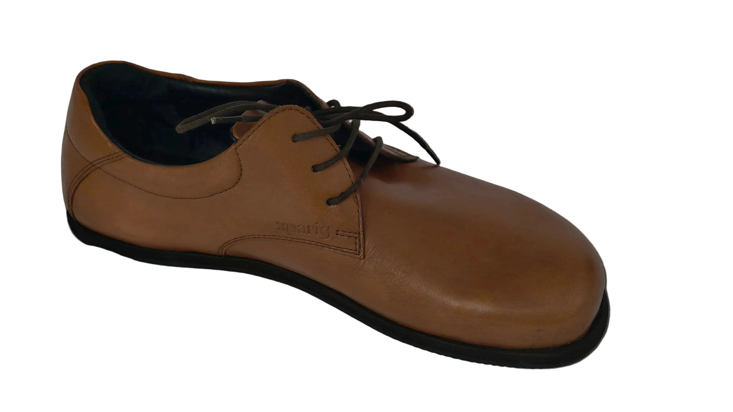 Brown leather shoe with black sole on a gray background