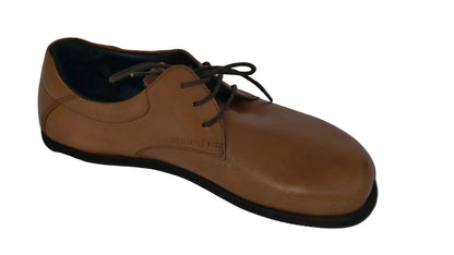 Brown leather shoe with black sole on a gray background