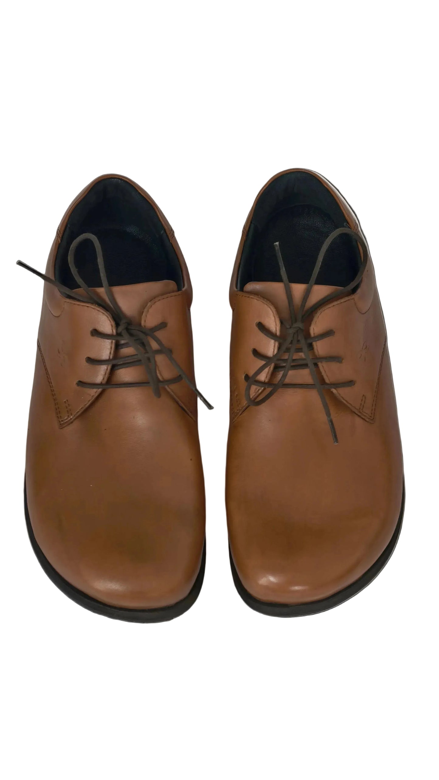 Pair of brown leather shoes with black laces on a white surface