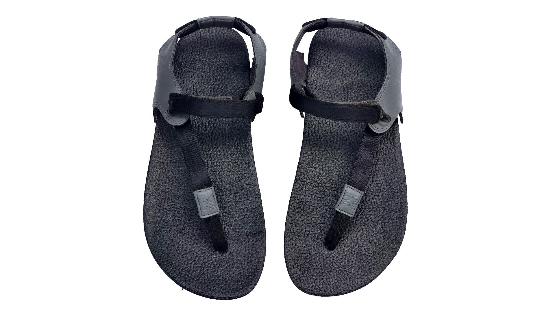 Pair of black sandals with straps on a white background